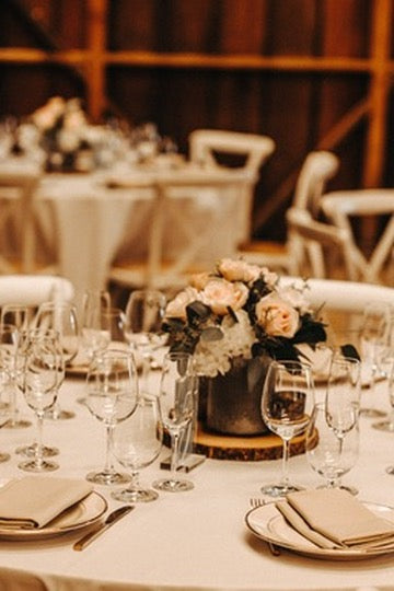 Decorated table with flowers and glasses in a warm-toned room