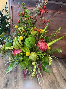 Bouquet of flowers with greenery on a wooden surface