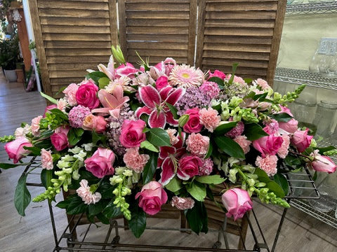 Lovely Lilies and Priceless Pink Roses Casket Spray