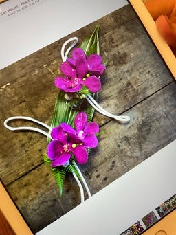 Floral corsage with pink flowers on a wooden surface