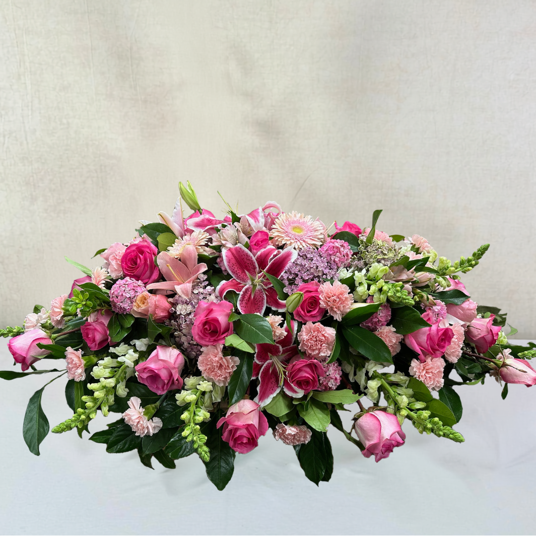 Lovely Lilies and Priceless Pink Roses Casket Spray